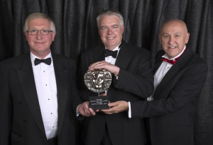 Phil George and John Roberts receiving the award from Carwyn Jones (Photo: BAFTA Cymru / Huw John)